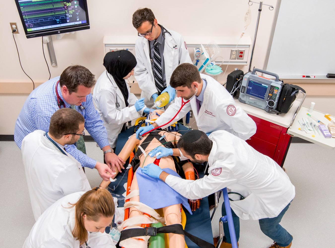 Medical students working on dummy in simulation lab