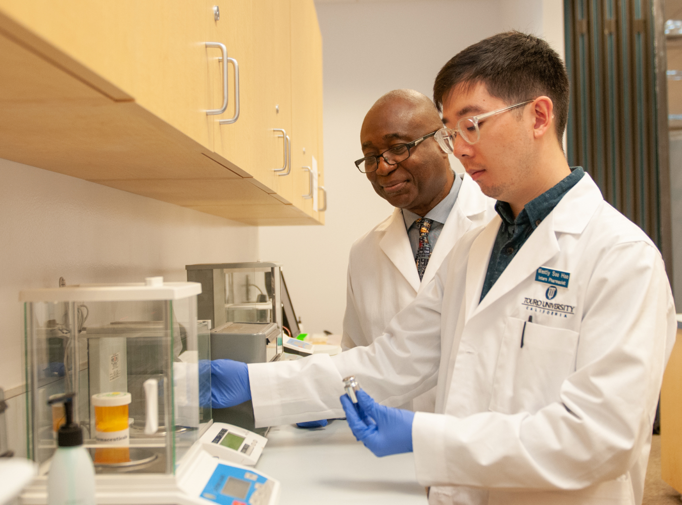 Student working with faculty member in medical lab