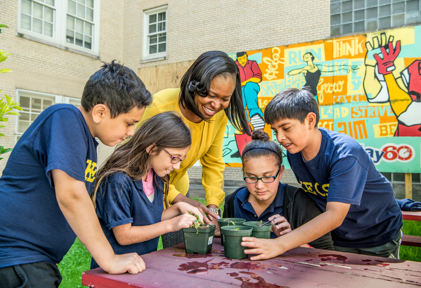 GSE alum smiling while working with students.