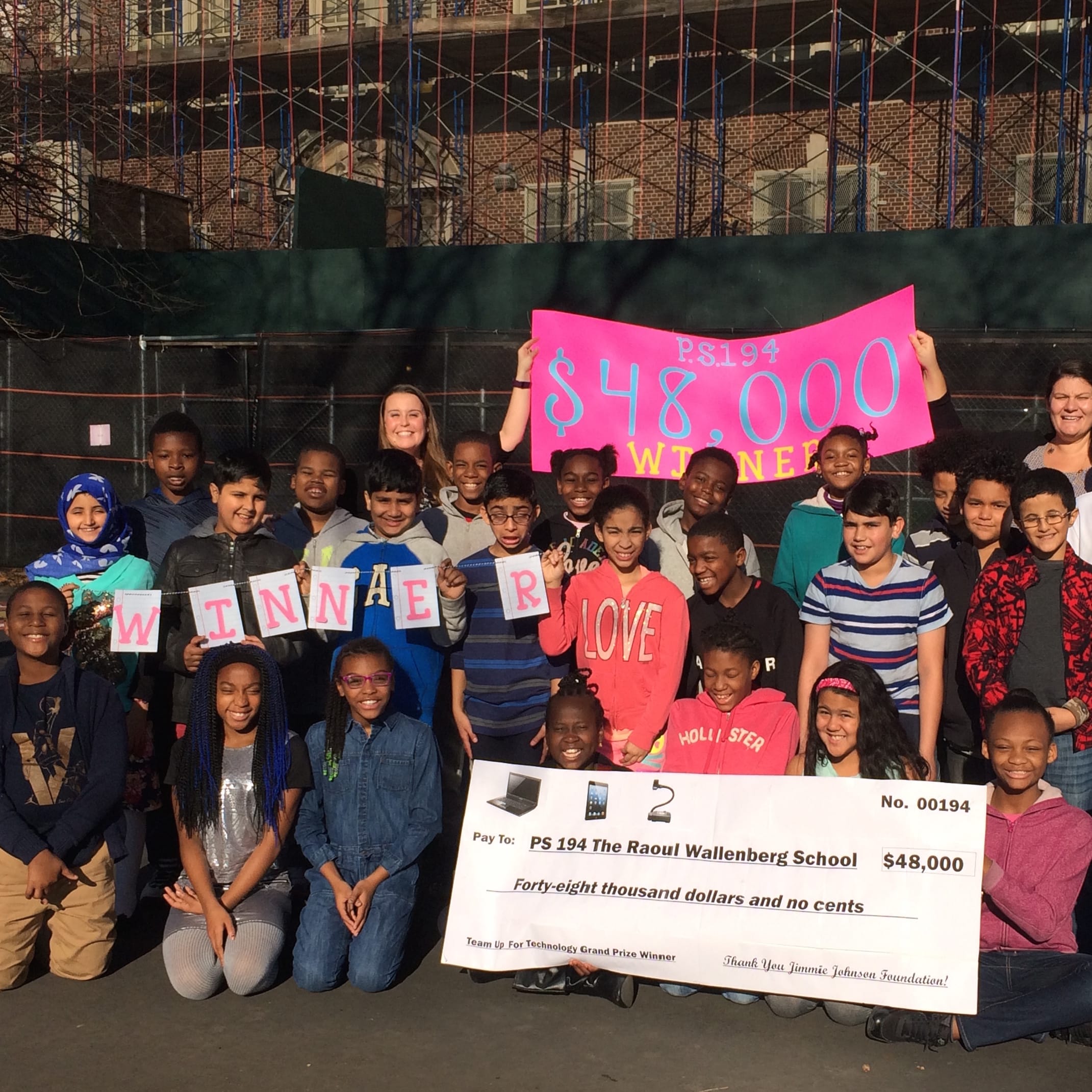 Kathryn Malara (holding the sign, top left), a graduate of Touro's Graduate School of Technology, helped her school win a $48,000 technology grant. 