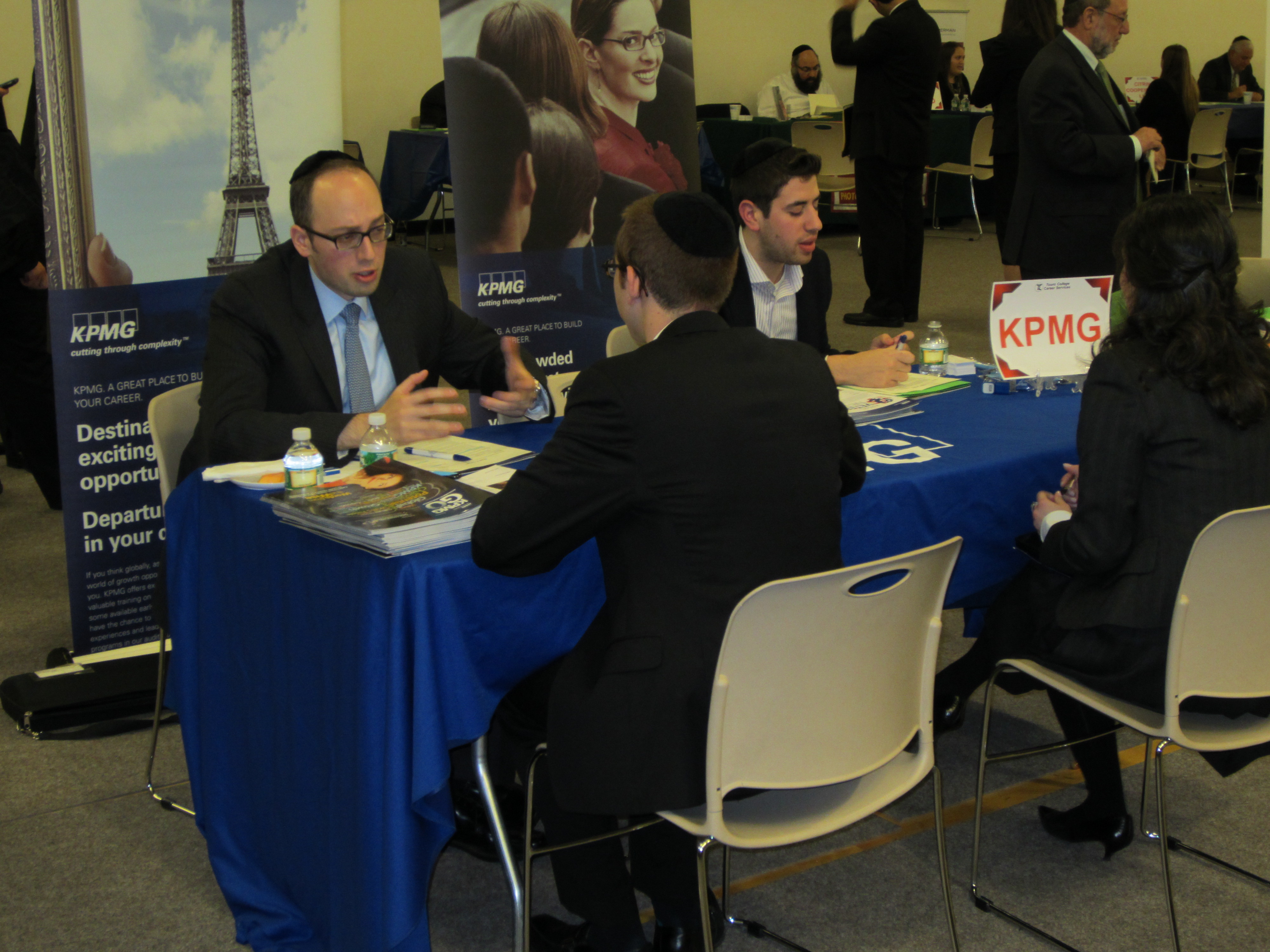 Students interview at KPMG during Touro College's career fair. 