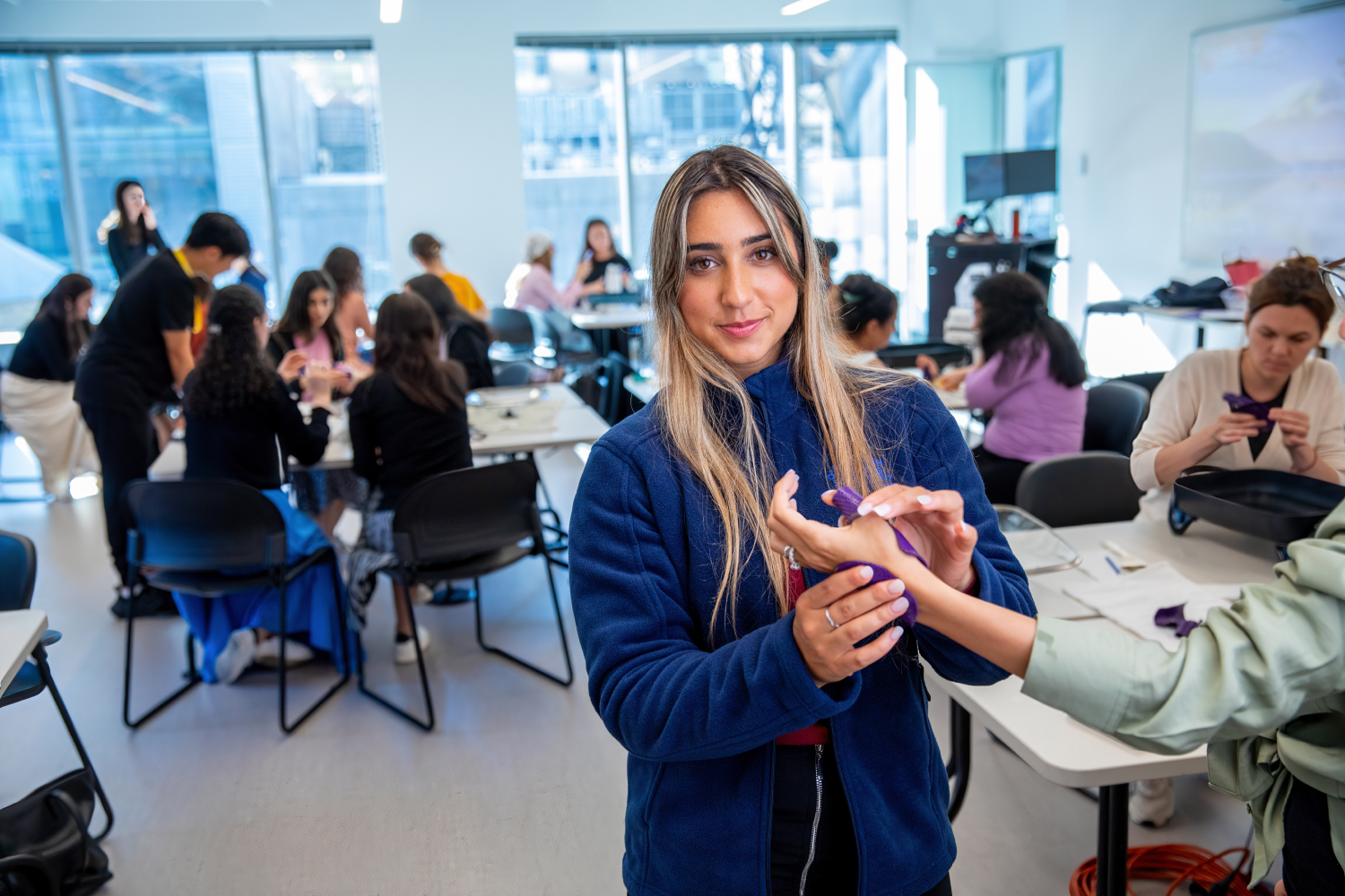 Sarah Iskhakov practicing hand therapy in splinting class